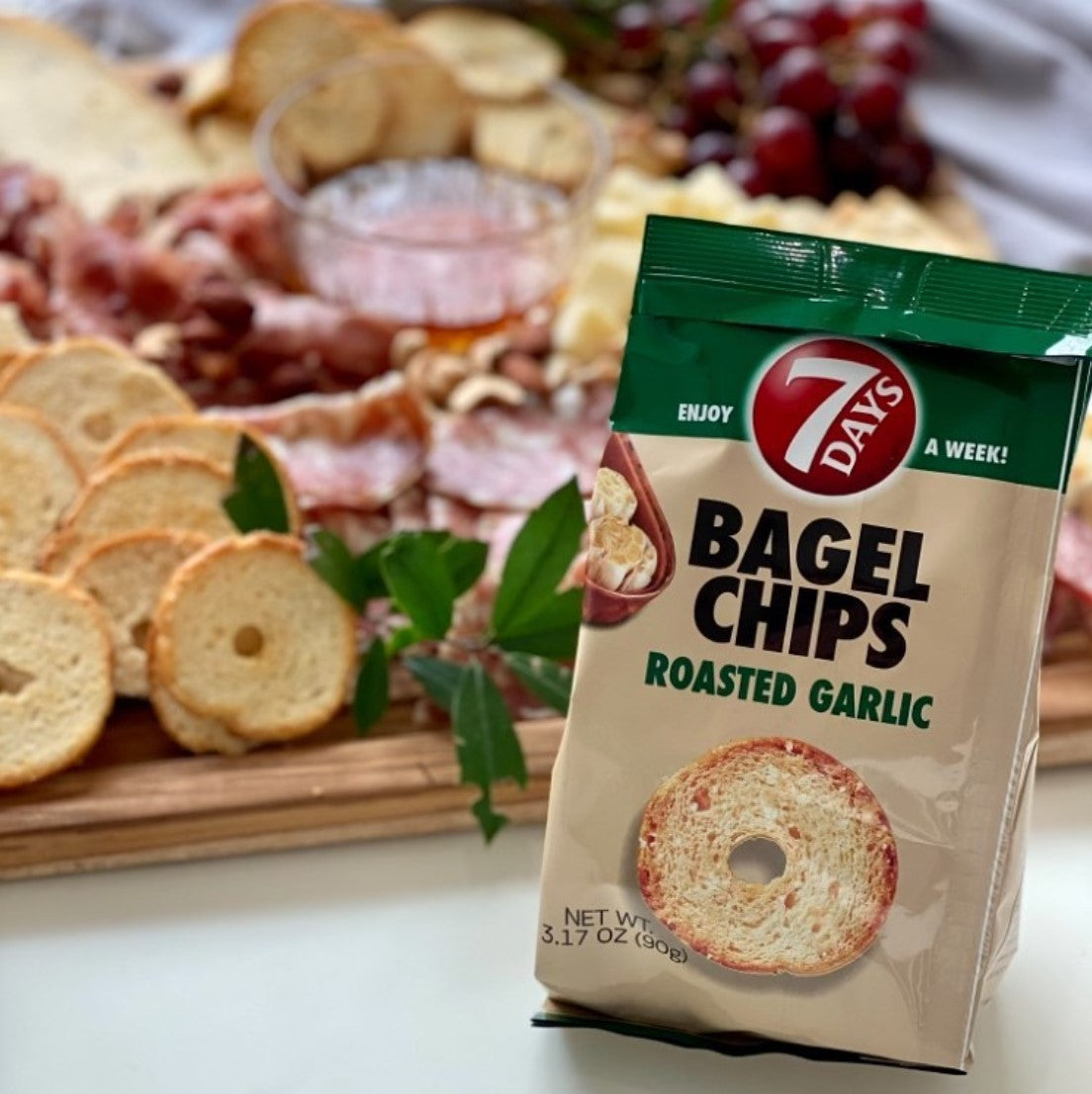 Bagel chips roasted garlic on a tray with salami